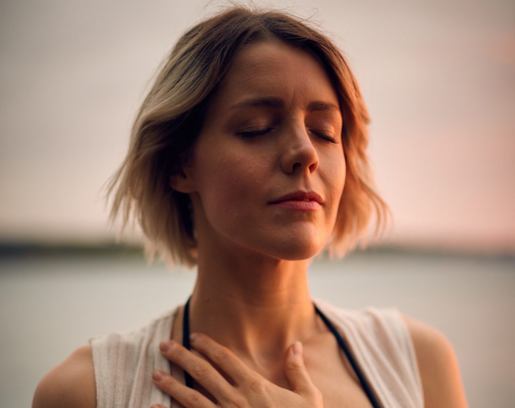 woman meditate hand on heart