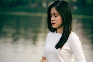 woman meditate still lake