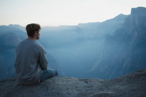 man meditates mountain