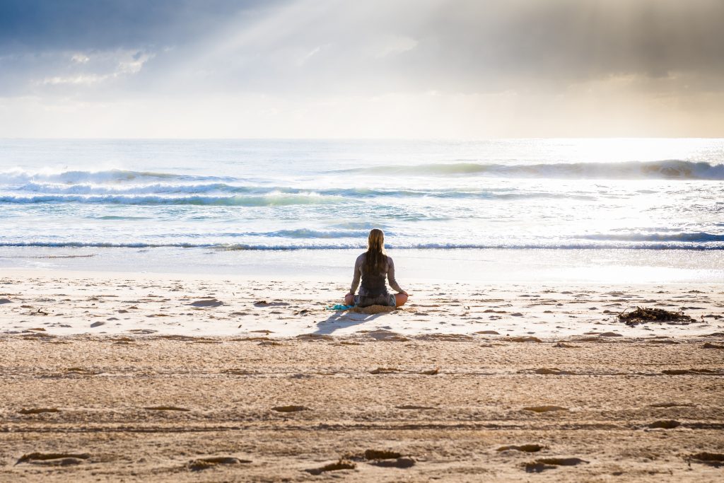 woman meditate beach