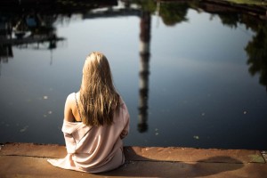 woman meditate lake