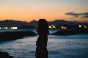 woman on water at dusk